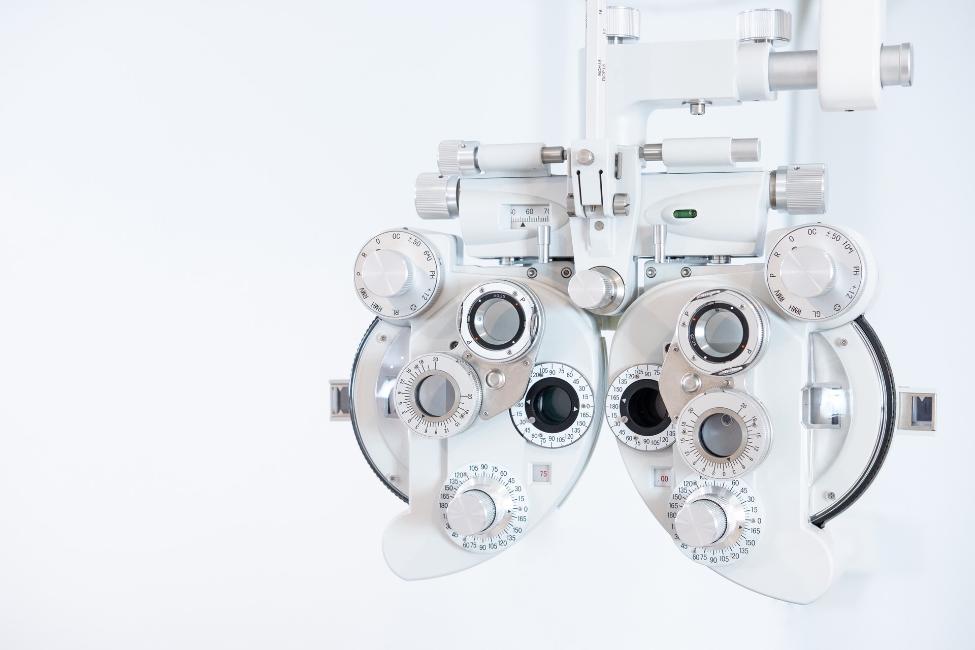 Selective focus at Optometry frame equipment. With blurred white background for copy space. Optometrist tool to examine eye visual system of patient with professional machine before made glasses.